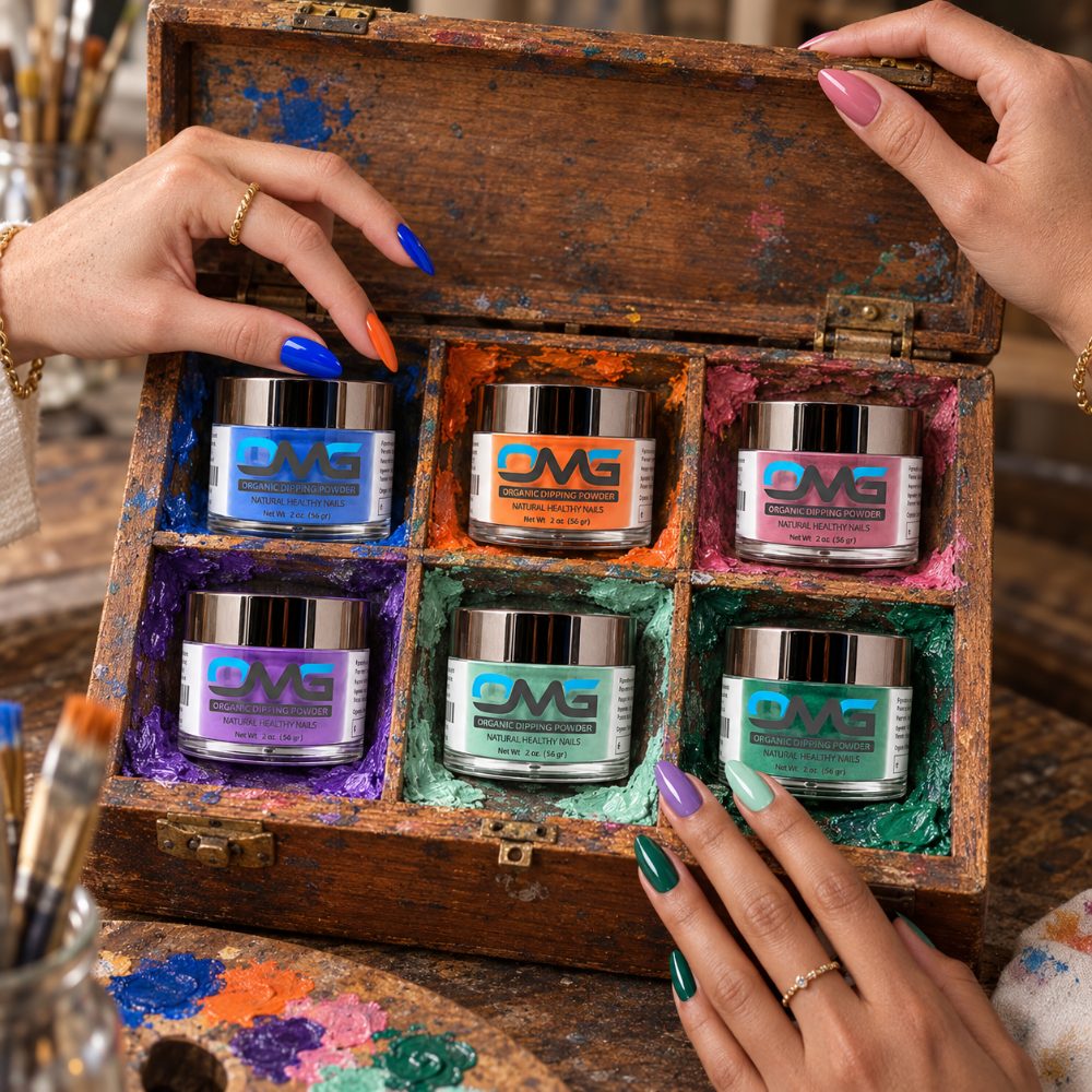 Hands with bright nails opening a wooden paint box holding six OMG organic dipping powder jars